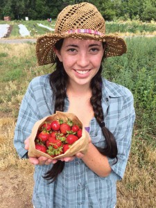 Savannah Snody of Growing Gardens proudly displays some of the very first strawberries harvested this past summer from the new urban orchard being planted at Boulder’s Growing Gardens.