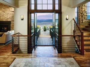 This stunning entry is a complete extension to the outdoors. “Flooring, wall sconces and railings were purposely kept minimalist, so as not to compete with nature’s beauty but rather complement it,” says designer Jennifer Jelinek.