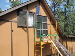 A six-panel SunnyTherm being installed on a workshop in the mountains near Boulder (the blue rectangle above the panels is a solar panel that runs the blower fan, making this system completely off-grid). The owner, a weaver, was tired of having to wait for hours for her studio to warm up enough to work in. With the system in place, the space is warm in the morning when she wants to use it, she reports, and her electric-heating costs have dropped 80 percent. 