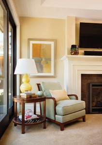 Pale blues and yellows create a serene sitting area in this master bedroom.