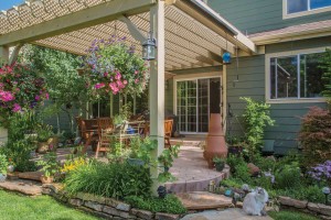 The new, larger patio with a pergola offers space to enjoy the garden and the water feature on sunny days and summer nights. 