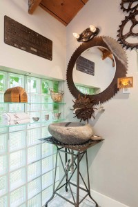 The agrarian implements in the powder room are a nod to the home’s agricultural past.