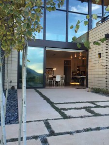 A 10-by-18-foot triple-glazed lift-slide door creates a seamless flow from the home’s interior to the semiprivate courtyard outside. Photo by Rosemary Fivian Architect Inc.