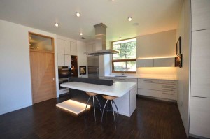 Family and friends visited the studio of Gerhard Oehrlich Concrete Design to select and scatter the glass in the kitchen’s concrete countertops. The cabinets are made from recycled paper. Photo by Rosemary Fivian Architect Inc.