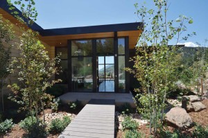 When the front door is open, a simple entry bridge on a north-south axis leads the eye from the driveway all the way through the house to the landscape beyond on a carefully planned procession. Photo by Rosemary Fivian Architect Inc. 