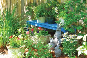 “The blue bench I painted myself when a friend suggested blue accents for our yard,” Kristin says of the teak bench they found in the alley. The houseplants atop the bench summer outdoors and overwinter indoors. The bunny sculptures add “variety and softness” to the garden, Kristin says. “I like the animals, and so do my grandchildren.” Photo by Allison M. Fleetwood Jr., wwwamfjphotography.com.