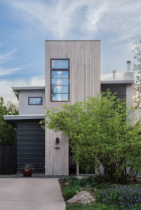 Two-inch vertical tongue-and-groove cedar siding clads the stair tower’s exterior. After much deliberation, Warner and Reisinger chose a bleaching stain to mute the wood’s color variations and to highlight the existing eggplant-colored window frame. A dramatic counterpoint to the original long, low ranch house, the tower is integral to the home’s new geometric composition. (Photo by Chris Nyce, Nyceone Photography, www.NyceOnePhotography.com)