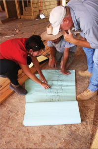 Kirsten Snobeck of Rodwin Architecture consults with the Skycastle Construction crew on a green design-build project. (Photo courtesy Rodwin Architecture)