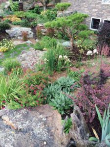 Red penstemons, silver-leaved yarrows, white ‘David’ phloxes, yellow ‘Moonbeam’ coreopsis and daylilies, orange gaillardias, Japanese blood grass, white snow-in-summer and Turkish veronica are just some of the many plants in the front beds. (photo by Scott Deemer, courtesy Outdoor Craftsmen)