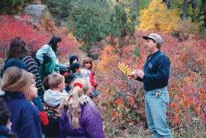 On a Spanish-language nature hike,  Dave Sutherland and Uni Hill elementary students explore why leaves change color.  