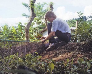 As a Peace Corps volunteer in Honduras, Sutherland repairs the long fishing net farmers used to harvest tilapia. 