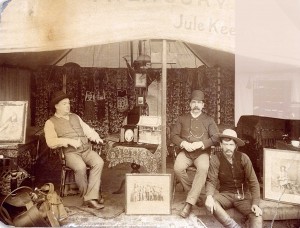 The Treasury tent of Buffalo Bill’s world-famous Wild West Show, probably around 1900.  The photo shows (left to right) Jule Keen, the show’s treasurer; William McCune, a former Army colonel; and Jim Mitchell, a “pretty tough” cowboy who rode bucking broncos. Behind Mitchell is a safe with a throw over it. You can see the combination lock for the safe.  (Photo courtesy Buffalo Bill Museum and Grave0