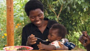 In a scene from Boll’s film A Small Good Thing, a Rwandan mother feeds her child. Farmers from Massachusetts went to Rwanda to teach about composting. (photo by Mystic Artists)