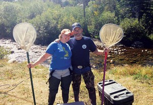 Larry Rogstad and his daughter Kelsey on a routine fish-sampling assignment, electrofishing the Big Thompson River. After an electric charge is induced in the stream, trout and other fish are stunned and netted, data are taken and the fish are released back to the stream alive. All Colorado streams and lakes are sampled periodically to provide data for management. (Photo by Jason Duetsch)