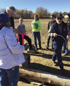 On a habitat-improvement volunteer day, wildlife manager Larry Rogstad teaches Centaurus High School students and neighbors how to build floating logs for birds and reptiles. (Photo by Julie Marshall)