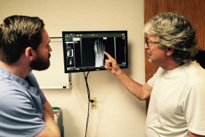 Tom Shonka (right) and Brian Gradisek, podiatrists at Foot and Ankle Care of Boulder County, review a successful fusion of an arthritic great-toe joint in a nationally competitive age-group triathlete. Their office specializes in sports medicine, biomechanics, and reconstructive surgery of the foot and ankle. (photo courtesy Foot and Ankle Care of Boulder County)