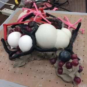 “Autonomic Healing” started with clusters of ceramic forms and star-shaped pink rubber. (photo courtesy Katie Caron)